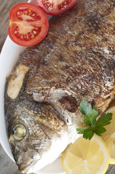 Fried (roasted) Fish (Dorado) Garnished with Lemon, Tomato — Stock Photo, Image