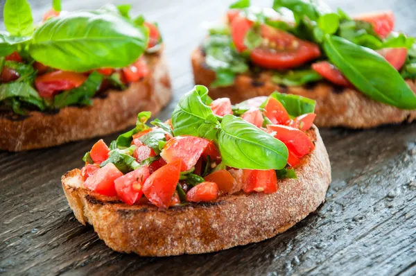 Italian tomato bruschetta with chopped vegetables — Stock Photo, Image