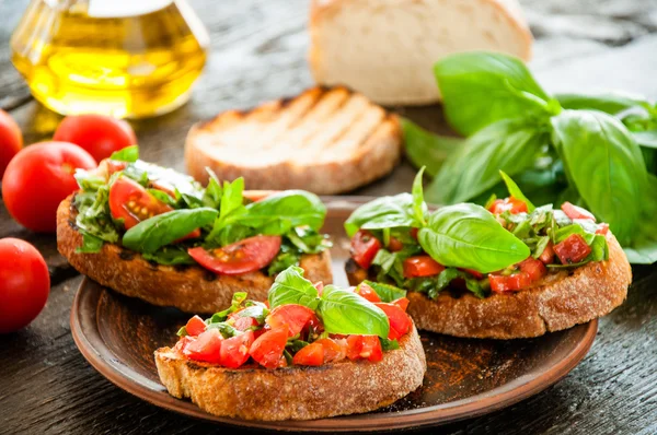 Italian bruschetta with chopped vegetables, herbs and oil on gr — Stock Photo, Image