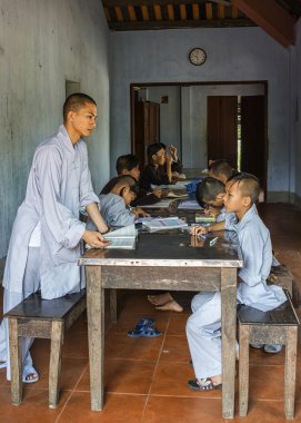 Vietnam Hué Royal Buddhist Thien Mu Pagoda: Teacher and pupils. clipart