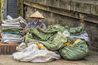 plastik torbalarda eski: Hanoi sokak kadını onarır.