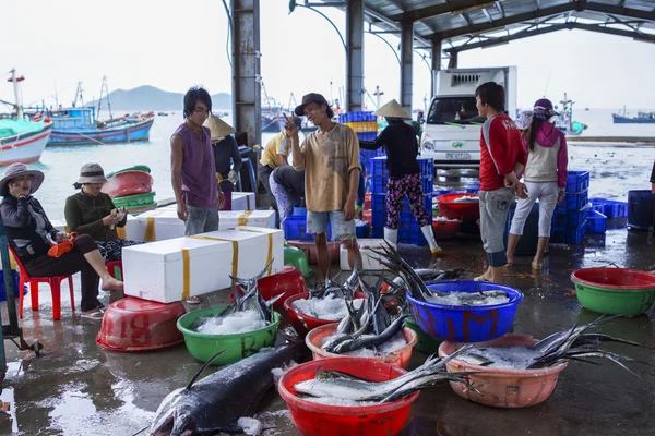 Fischer und Frauen sortieren Fische im Hafen. — Stockfoto