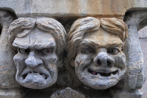 Fresco of angry and happy male's face set in stone. — Stock Photo, Image