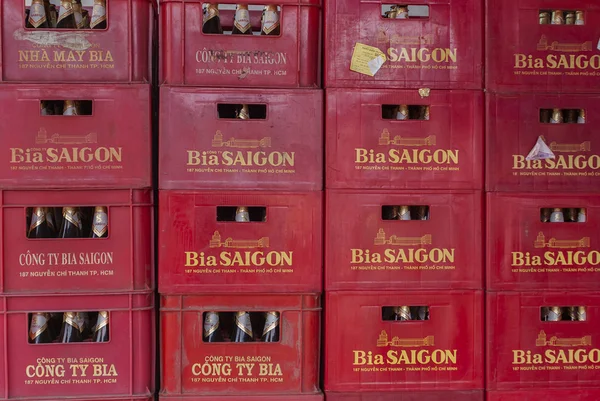 Stack of crates with 'Saigon' beer bottles.