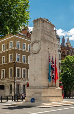 London, UK - July 4, 2022: Along Whitehall A3212, The Cenotaph, National War Memorial and remembrance site is beige stone tower with British flags on side in middle of street