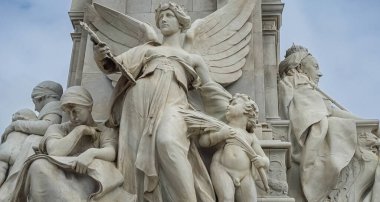 London, England, UK - July 6, 2022: Victoria Memorial. Fisheye closeup of Truth statue combination. Motherhood left, and enthroned queen on the righ side. Light blue sky.