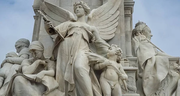 London, England, UK - July 6, 2022: Victoria Memorial. Fisheye closeup of Truth statue combination. Motherhood left, and enthroned queen on the righ side. Light blue sky.