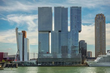 Rotterdam, Hollanda - 11 Temmuz 2022: Kop van Zuid rıhtımında KPN logosu, DE Rotterdam ve New Orleans gökdelenleri bulunan Toren-op-Zuid. Beyaz yolcu gemisi