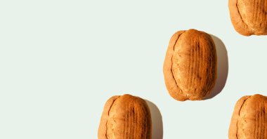 Composition from bread with shadows on blue pastel soft color background. Sourdough bread. Eco-friendly products. Still life. Copy space. Food concept. Space for text. Banner