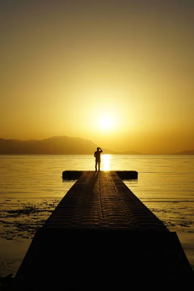 beautiful silhouette of a man on the sea at sunset,