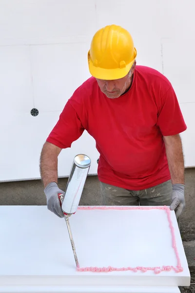 Construction site, styrofoam insulation glue — Stock Image Construction site, styrofoam insulation glue Royalty Free Stock Photos