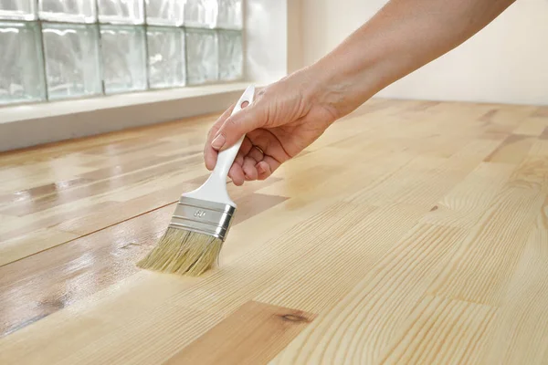 Varnishing Pine Wooden Plank Floor Stairs Workers Hand Paint Brush Obrazy Stockowe bez tantiem