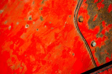Rusty and dirty metal surface with old red paint.