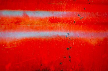 Rusty and dirty metal surface with old red paint.