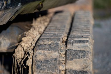 Close-up of the caterpillar of a small excavator.