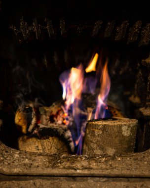 Burning wood in the old heating stove in the house.