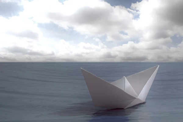 Paper boat floating in the sea Stock Photo