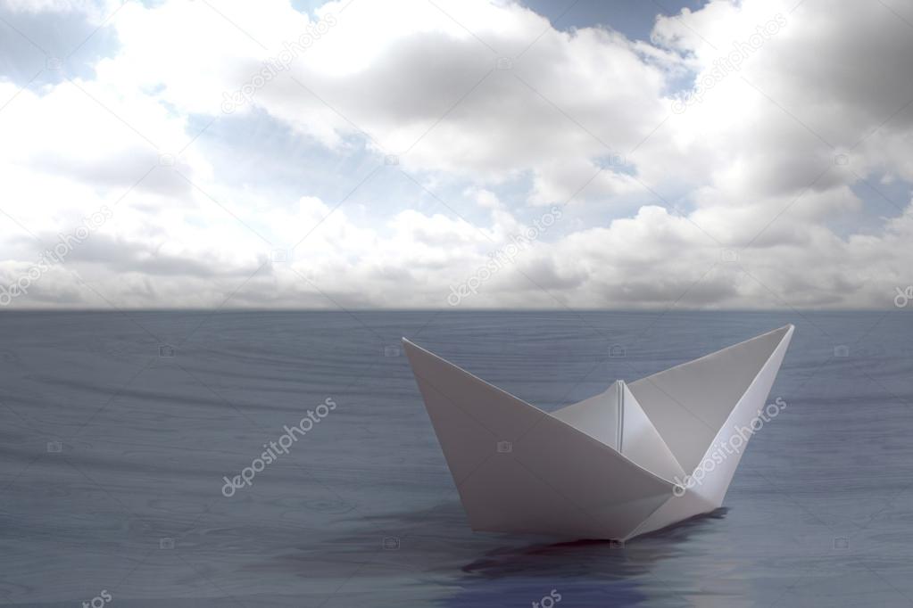 Paper boat floating in the sea