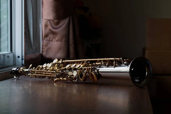 Soprano Saxophone Mouthpiece, Closeup Woodwind Instrumental Equipment on Blur Saxophone Background.