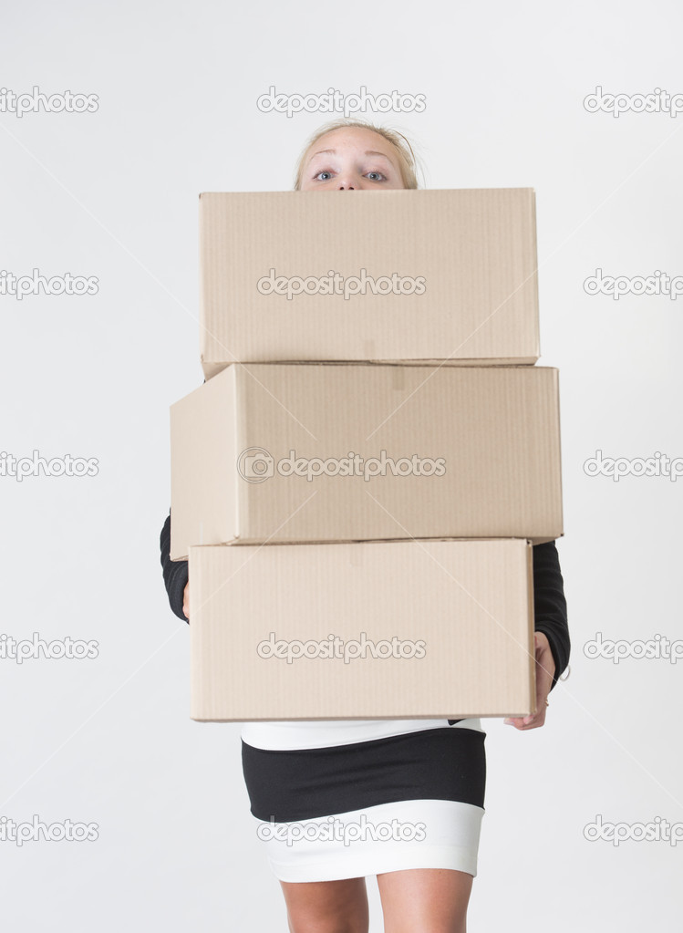 Woman carrying carboard boxes