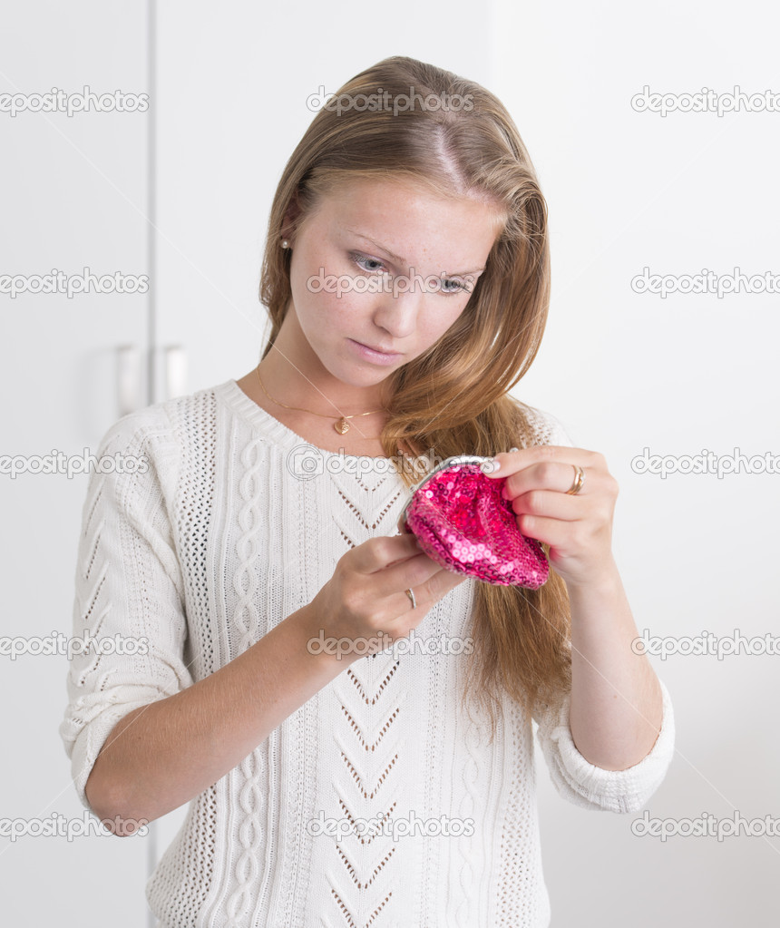 Young woman holding pink purse looking troubled