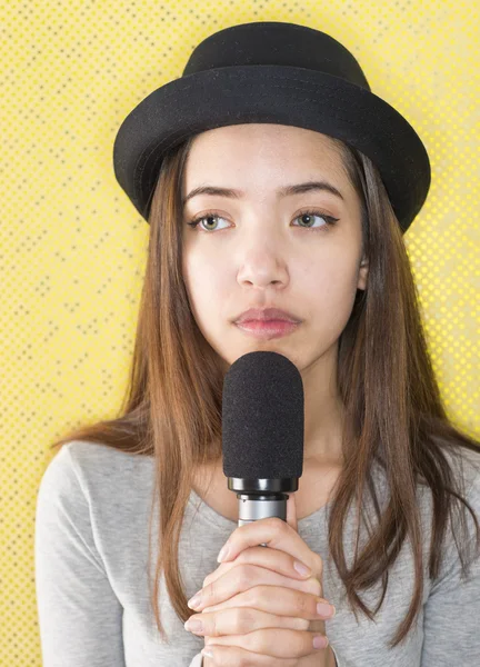 Atractiva joven cantando con micrófono — Foto de Stock