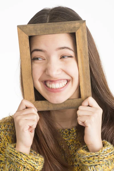 Attractive young woman holding wooden frame — Stock Photo, Image