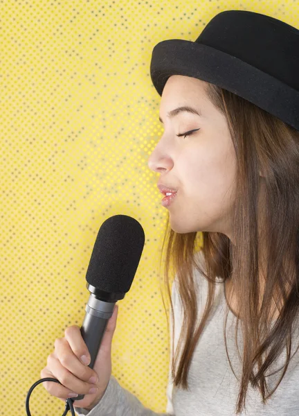 Attractive young woman singing with microphone