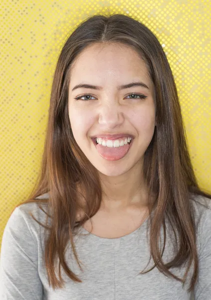 Teasing young woman sticking out tongue — Stock Photo, Image