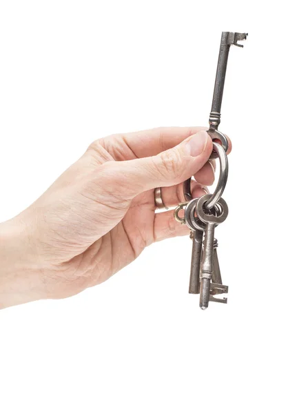 Hand holding old skeleton keys — Stock Photo, Image