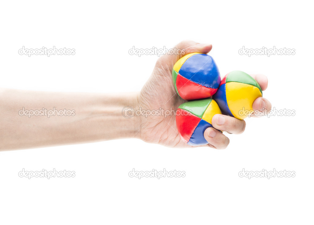 Hand holding three juggling balls