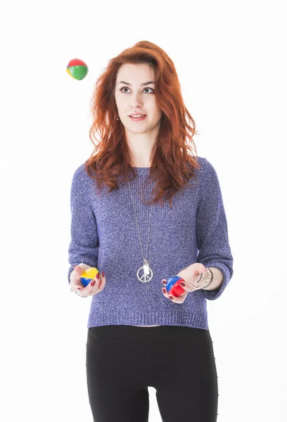 Pretty young female juggling balls — Stock Photo, Image