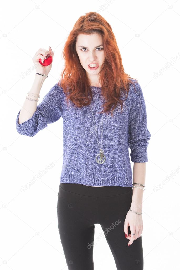 Mad and upset young woman holding red ball