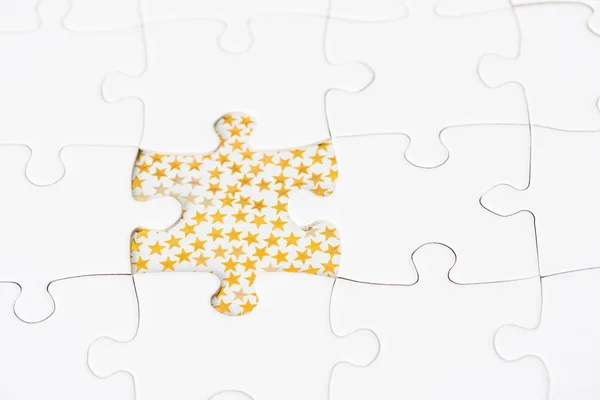 White puzzle and golden stars — Stock Photo, Image