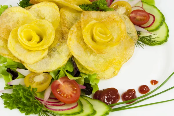 French fries in the form of a rose on a plate with a salad — Stock Photo, Image