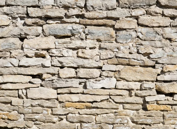 Kalksten väggen på en solig dag som bakgrund — Stockfoto