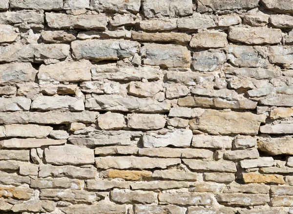 Pared de piedra caliza en un día soleado brillante como fondo — Foto de Stock