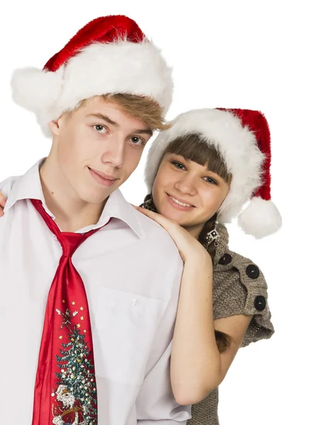 Smiling girl and the guy in red santa caps on a white isolated b — Stock Photo, Image