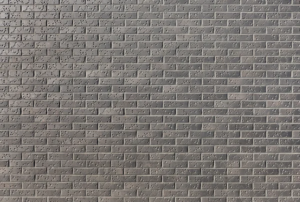 Mur d'une brique sombre avec un motif dans une journée ensoleillée brillante comme un — Photo