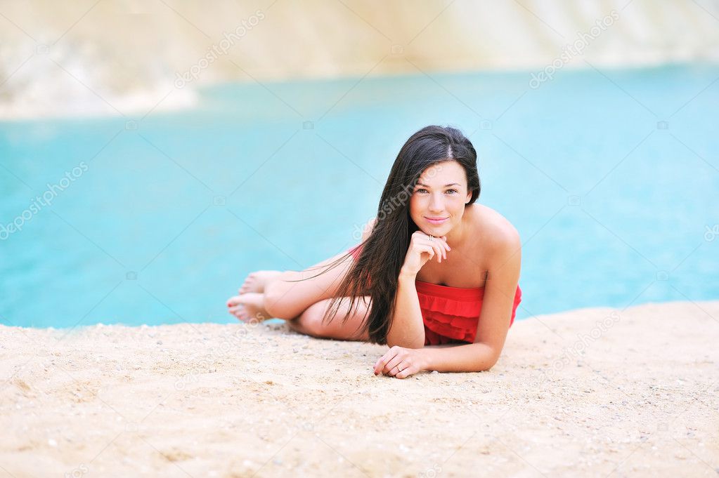 Young beautiful girl on a beach relaxing near a copyspace