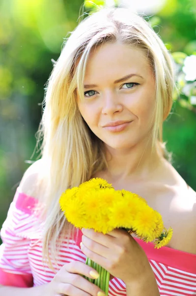 Young beautiful girl with dandelions — Stock Photo, Image