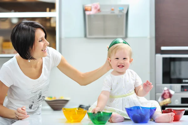 Mother and daughter cooking together and having fun on a kitchen — Stock Photo, Image