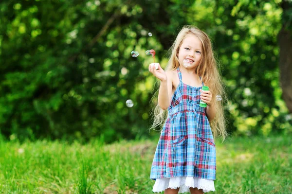 Bambina con bolle di sapone nel parco — Foto Stock