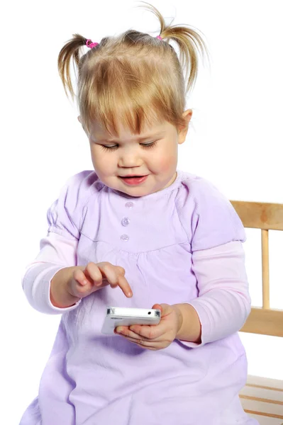 Adorable petite fille utilisant un téléphone mobile sur fond blanc — Photo