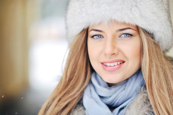 Close up of a beautiful girl face in winter fur hat — Stock Photo, Image