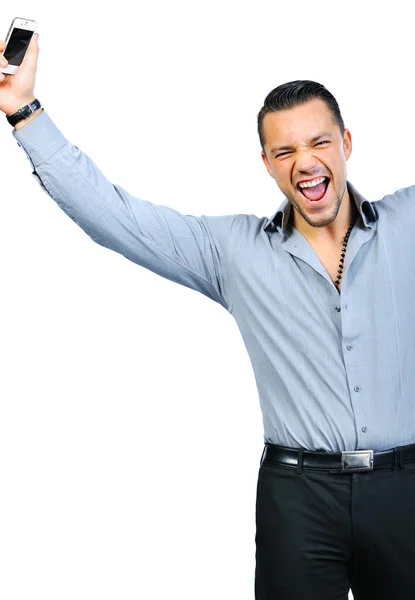 Young man holding mobile phone and winning something — Stock Photo, Image