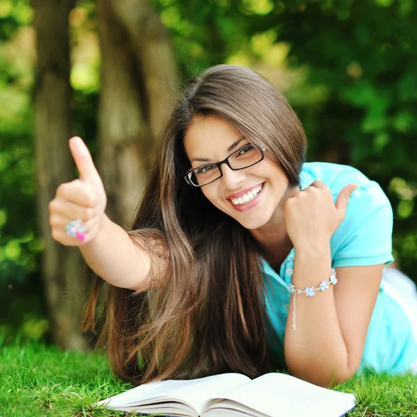 Portrait of young happy smiling cheerful woman in glasses lying Stock Picture