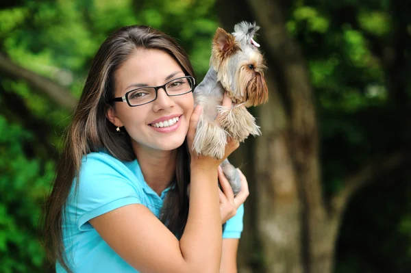 Young girl with her yorkshire terrier puppy outdoors — Stock Photo, Image