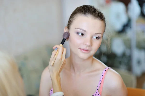 Beautiful young woman applying wedding make-up by make-up artist — Stock Photo, Image