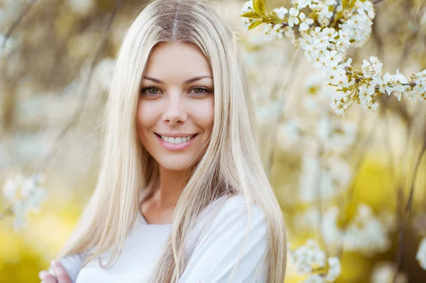 Närbild på vackra blonda kvinnan i parken — Stockfoto